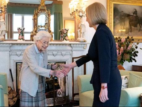 Britain’s Queen Elizabeth II (left) welcomes Liz Truss during an audience at Balmoral, Scotland, where she invited the newly elected leader of the Conservative party to become prime minister and form a new government, on Tuesday, September 6. 