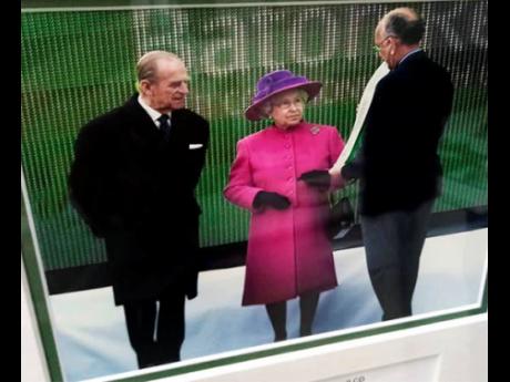 Credit: Contributed A photo of Mike Fennell (right) with Queen Elizabeth II and husband Prince Philip.