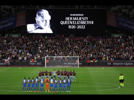Players stand on the pitch during minute's silence following the death of Queen Elizabeth II on Thursday.  The minute's silence was observed before the start of  the Group B Europa Conference League football match between West Ham and FCSB Steaua Bucharest