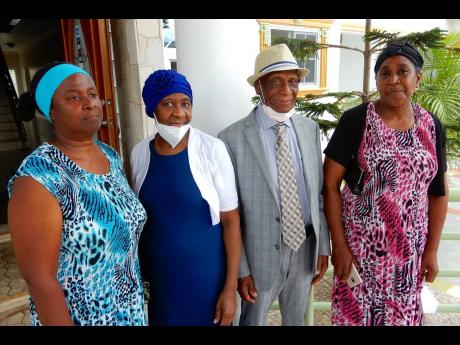 Pastor Smith with his three daughters, from left – Lisa, Jean, and Winsome 