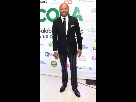Michael Collins, manager, Youth Banking Unit,  JN Bank, went for a playful look in stripe pants and a  black dinner jacket.