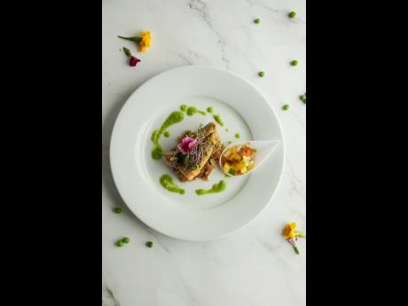 Marcella Evans-Ingram’s pan-fried snapper fillet, coupled with her deep-fried lobster and coconut-infused shrimp.