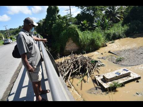 Credit: Mark Titus
Senior resident Henrick Neville says the failure of the NWA to remove the debris from the Montego River after five months could spell danger for the community of West Green in Montego Bay, St James.