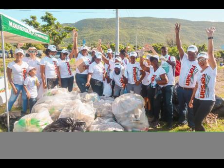 Staff from Newport-Fersan (Jamaica) Ltd take the time for a photo while at Sigarny Beach for the Kingston Harbour Beach Clean-up project, implemented on International Coastal Clean-up Day earlier this month.