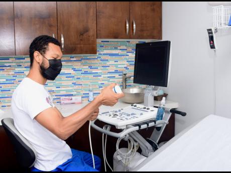 Jhovany Fantauzzi (Cardiovascular technician) operates one of the heart-monitoring machines at the Heart Smart Centre at the GWest Medical and Surgery Centre in Montego Bay, St James, during a heart-health fair hosted at the Centre on Thursday, September 2