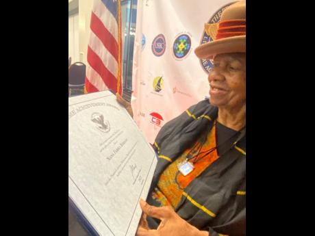 Nana Farika Berhane reads the inscriptions on the United States President’s Lifetime Achievement Award given to her by President Joe Biden.