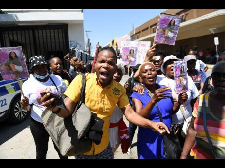 Vlogger Andre Stephens and other protesters are seen outside the Supreme Court building Tuesday while a hearing was under way into Constable Noel Maitland’s alleged murder of girlfriend Donna-Lee Donaldson.