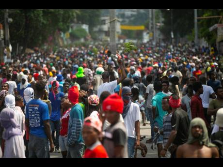 Credit: AP Demonstrators fill the streets during a protest to demand the resignation of Prime Minister Ariel Henry, in the Petion-Ville area of Port-au-Prince, Haiti, on Monday, October 3.