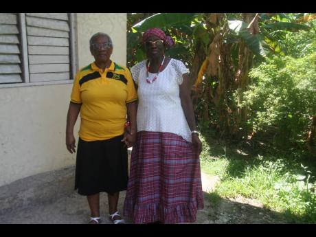 Credit: Bryan Miller President of the Hanover chapter of the Retired Teachers Association (RTA), Merletta Donaldson (left), and a member, Matilda Wainwright-Bowen, who is dressed in the Jamaican bandana, get ready for their presentation at the meeting of the group on Tuesday