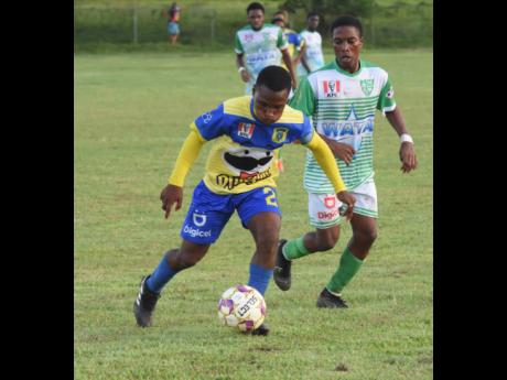 Credit: Ashley Anguin Rusea’s High’s Kimarly Cope (left) getting away from Frome Technical High’s Akeem Kongal during an ISSA/Digicel daCosta Cup football match at the Rusea’s Sports Complex on Tuesday, September 27. Frome won 3-0.