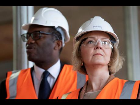 UK Prime Minister Liz Truss and Chancellor of the Exchequer Kwasi Kwarteng look on during a visit to a construction site for a medical innovation campus, on day three of the Conservative Party annual conference at the International Convention Centre in Bir