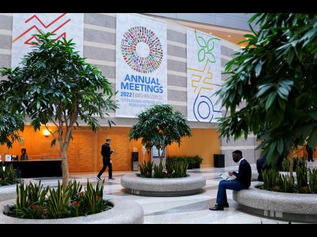 Attendees gather inside an atrium at the 2022 annual meetings of the International Monetary Fund and the World Bank Group on Monday, October 10, in Washington.