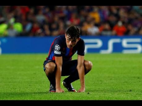 Barcelona’s Pedri gestures after Inter Milan’s Robin Gosens scores his side’s third goal during the Champions League Group C soccer match between the two at the Camp Nou stadium in Barcelona, Spain yesterday.