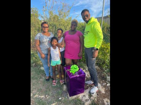 Brown presented Hannah, a resident of Gravel Heights in St Catherine, with a box of groceries.