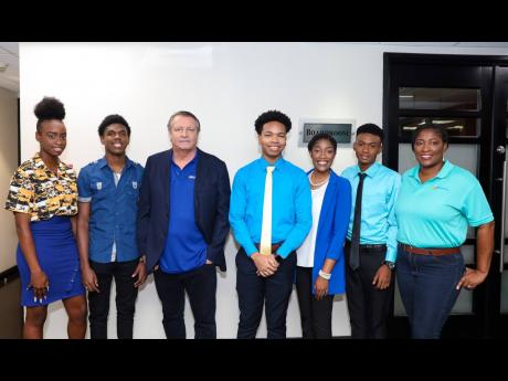 JWN Foundation Chairman JP Beyer (centre) and Chief Executive Officer Tanikie McClathy Allen (right), with scholars (from left) Martina Scarlett, Kyle Wilson, Malcolm Jarrett, Rhaveen Kildare, and Kevin Neil.