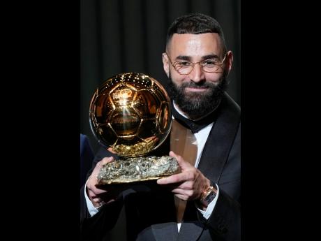 Real Madrid’s Karim Benzema celebrates after winning the 2022 Ballon d’Or trophy.