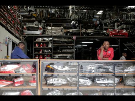 Salesmen wait for customers at a second-hand car parts warehouse in the industrial area of the capital Nairobi, Kenya, on October 7, 2022.