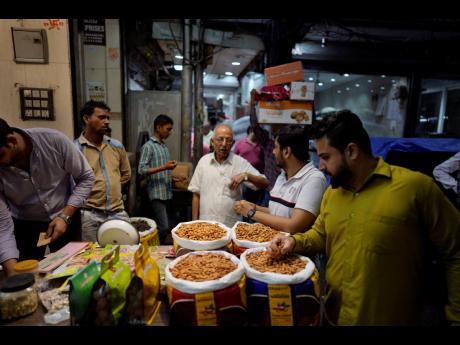 Small retailers shop for dry fruits in a wholesale market, in New Delhi on October 10, 2022.
