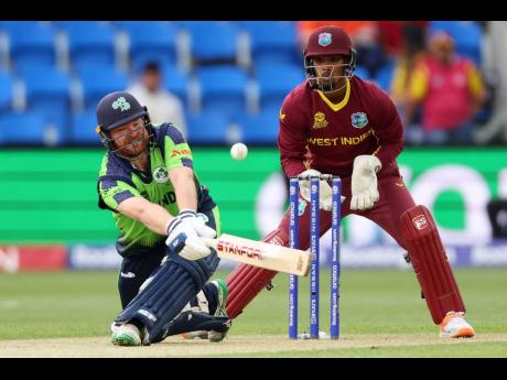 Ireland’s Paul Stirling on the attack during his unbeaten 66 against the West Indies in the qualification stage of the T20 World Cup  in Hobart, Australia yesterday. The wicketkeeper is West Indies captain Nicholas Pooran.  