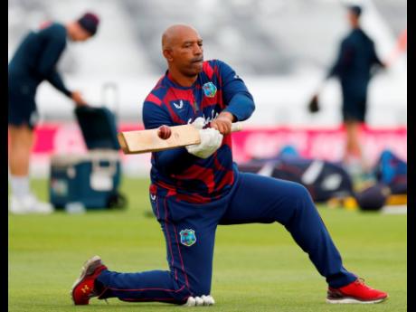 West Indies coach Phil Simmons gives his players catching practice during warm up on the second day of the first Test cricket match between England and the West Indies at the Ageas Bowl in Southampton, southwest England on July 9, 2020. 
