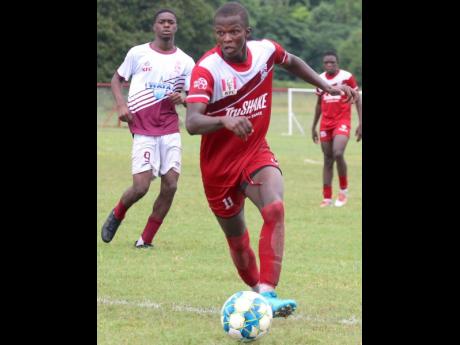 Credit: Lennox Aldred Glenmuir High’s David Reid (right) dribbles by Tacky High’s Deandre Jackson during the second leg of their second-round ISSA/Digicel daCosta Cup match at Glenmuir today. The hosts won 8-0.