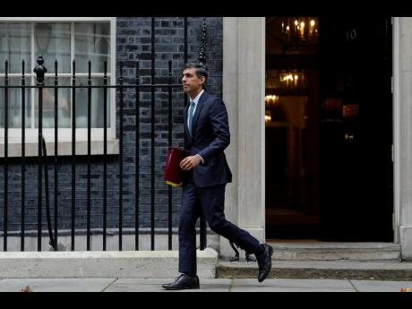Britain’s Prime Minister Rishi Sunak leaves 10 Downing Street for the House of Commons for his first Prime Minister’s Questions in London, on Wednesday, October 26.
