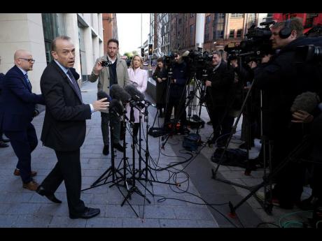 Northern Ireland Secretary Chris Heaton-Harris speaks to the media outside Erskine House, Belfast, Britain, on Friday October 28.