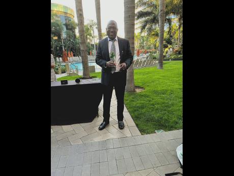  A gleeful Grennell stands with his award from the National Safety Council.