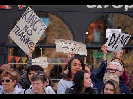 People protest as Britain’s King Charles III and the Queen Consort arrive at Cardiff Castle in Wales, September 16, 2022. King Charles III and Camilla, the Queen Consort, have arrived in Wales for an official visit. The royal couple previously visited to