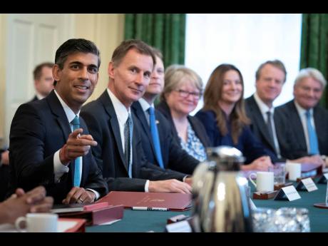 
Britain’s Prime Minister Rishi Sunak (left) alongside the Chancellor of the Exchequer, Jeremy Hunt (second left) holds his first Cabinet meeting in Downing street in London on Wednesday.