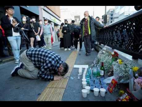 A man bows to pay tribute for victims near the scene of a deadly accident in Seoul, South Korea, following Saturday night’s Halloween festivities. 