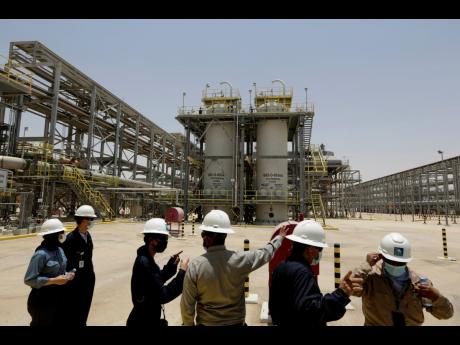 Saudi Aramco engineers and journalists look at the Hawiyah Natural Gas Liquids Recovery Plant in Hawiyah, in the Eastern Province of Saudi Arabia, in this June 28, 2021 photo. 