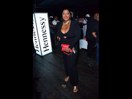 Credit: Contributed Jeanine Jackson, assistant sales manager, Sagicor Property Services Limited, strikes a pose in all black with a pop of red and gold.