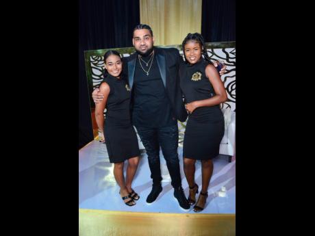 Credit: Contributed The man of the hour, Romeich, flanked by hostesses Mya Forbes (left) and Iyana Lawrence.