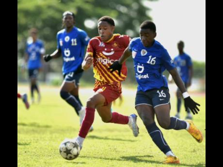 Wolmer's Boys' School's Dante Dacres (left) battles for the ball with Jamaica College's Rensonjr Sayers during their ISSA/Digicel Manning Cup quarterfinal game at Ashenheim Stadium on Saturday.