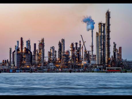 FILE - The sun sets at Chalmette refinery in Chalmette, La., located just over the Mississippi River levee May 3, 2020. While the Inflation Reduction Act concentrates on clean energy incentives that could drastically reduce overall U.S. emissions, it also 