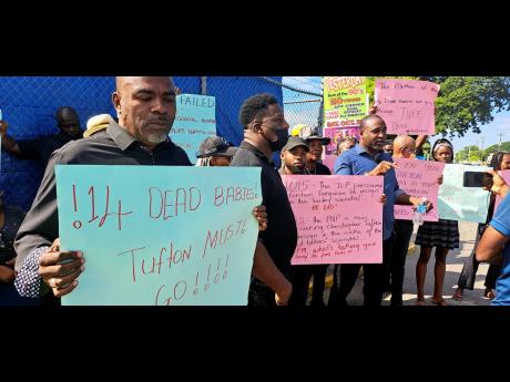
Waterford division Councillor Fenley Douglas (left), Treadways division Councillor Sidney Rose (centre), and PNP General Secretary Dr Dayton Campbell participate in a protest outside the Spanish Town Hospital on Monday. The demonstrators called for the re