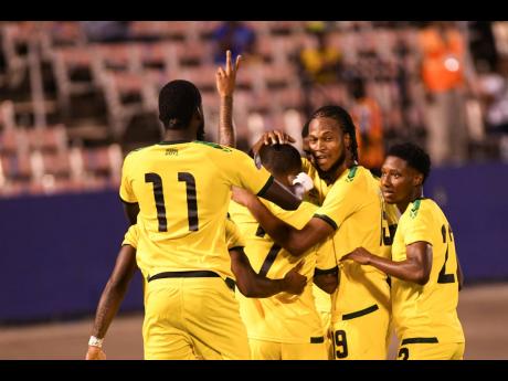Jamaica’s Reggae Boyz celebrate after Leon Bailey’s brilliant header gave the home team an early lead in last night’s Concacaf Nations League match against Mexico at the National Stadium.