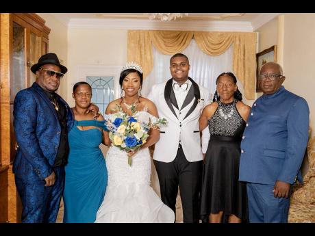 The bride and groom are joined by their supportive family members. From left: Patrick and Maxine Morris, parents of the bride, and Maxine Boothe and Rohan King. 