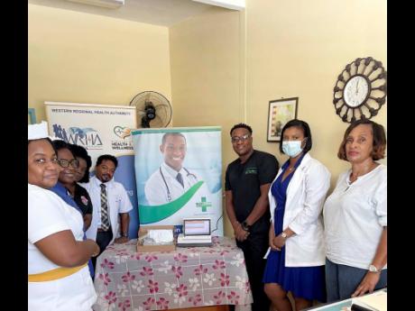 Dr Germaine Spencer (third from right), the chief executive officer of Baywest Wellness Clinics and Hospital, with staff members of the Cornwall Regional Hospital in St James, following a donation of a foetal monitor machine to the facility on Friday, Nove