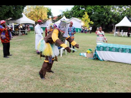 Credit: Paul Williams A masquerader performs in similar fashion to Jamaican Jonkonnu dancers.