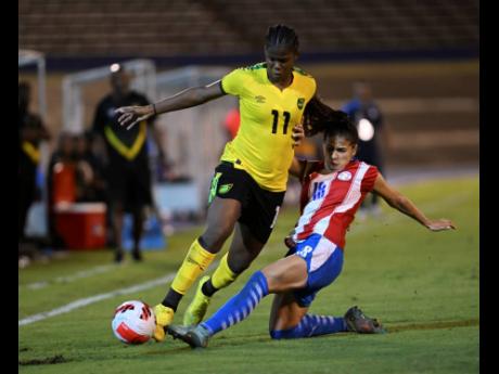 Jamaica’s Khadija Shaw (left) is tackled by Paraguay’s Camila Arrietta during Sunday night’s friendly international at the National Stadium. Paraguay won 2-1.