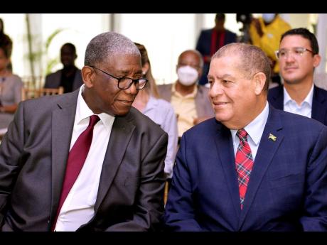 Credit: JIS Minister of Transport and Mining Audley Shaw (right) in discussion with chairman of Marathon Insurance Brokers, Richard Burgher, at the launch of MIBinsure platform, ‘Whatever You Drive’, yesterday at the Terra Nova All-Suite Hotel in Kingston.