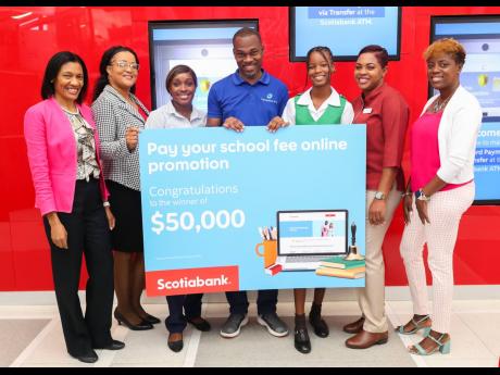 Sheila Segree-White (left), vice-president – customer experience and advocacy at Scotiabank, snaps a photo with county winners in the financial institution’s ‘Beat the Bell’ back-to-school promotion (from second left), Sherine Creighton, Cigale Wil