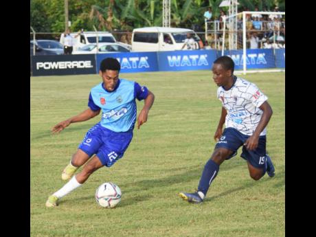 
Manning’s School’s Devonte Rodney (left) tries to shake off the attentions of Jamaica College’s Saviola Blake during an ISSA/Champions Cup quarterfinal football game at the STETHS Sports Complex yesterday.