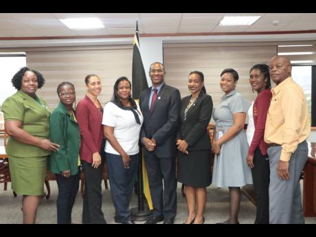 Nigel Clarke (centre), minister of finance and the public service, pose with Marsha Smith (fourth right), state minister; Debra Treasure (fourth left), president of the Council of Paramedics; Esther Campbell (left), president of the Jamaica Enrolled Assist