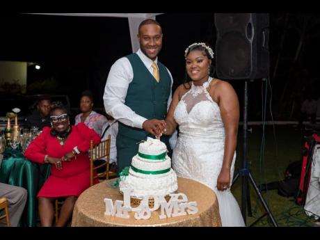 The bride and groom engage in the traditional cake-cutting ceremony at the reception.