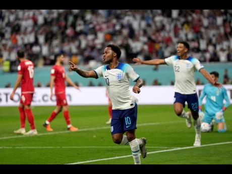 England’s Raheem Sterling celebrates after scoring his side’s third goal during the World Cup Group B soccer match against Iran at the Khalifa International Stadium in Doha, Qatar, Monday. England won 6-2.