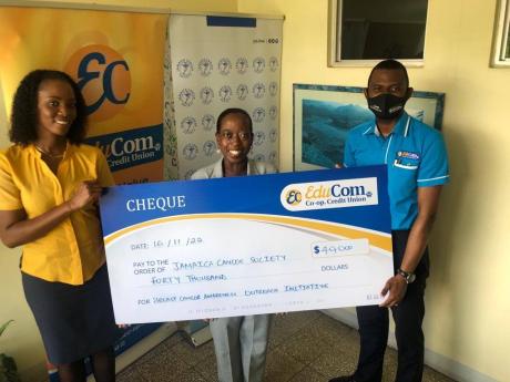 Anthoy Fagan (right), business development officer at EduCom Co-operative Credit Union, presents a symbolic cheque valued at $40,000 to representatives from the Jamaica Cancer Society Shannon McIntosh (left), senior accounting technician, and Shullian Brow