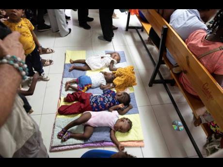Babies sleep as their parents wait their turn to have them checked for symptoms of malnutrition at the Gheskio Centre in Port-au-Prince, Haiti, on Monday, November 21. Manuel Fontaine, director of UNICEF’s Office of Emergency Programmes, visited the cent